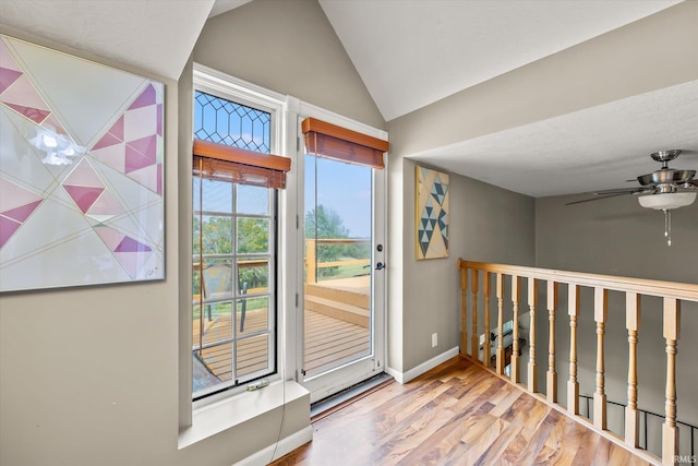 doorway to outside with hardwood / wood-style flooring and vaulted ceiling