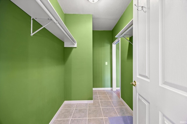 interior space featuring a textured ceiling and light tile patterned floors