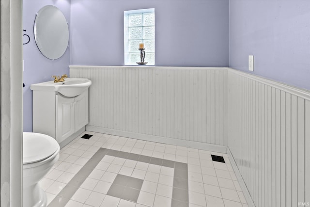 bathroom with tile patterned floors, toilet, and vanity