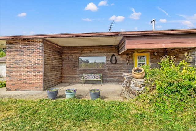 doorway to property with a yard