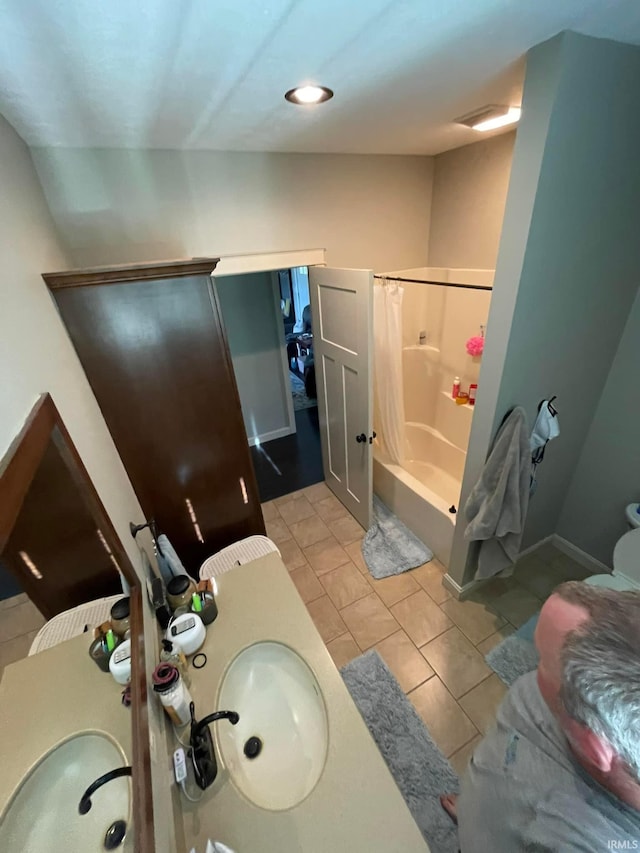 bathroom featuring tile patterned flooring, walk in shower, and vanity