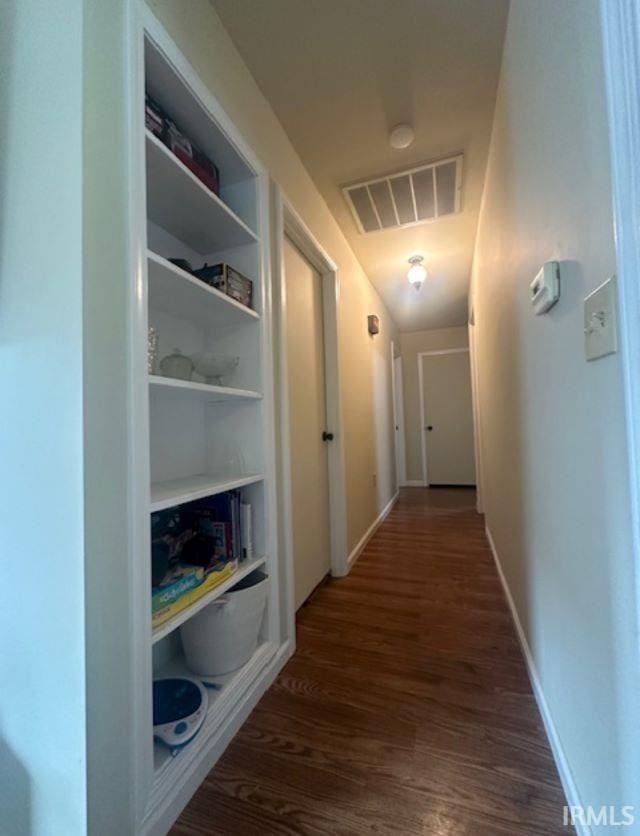 hallway with dark hardwood / wood-style flooring