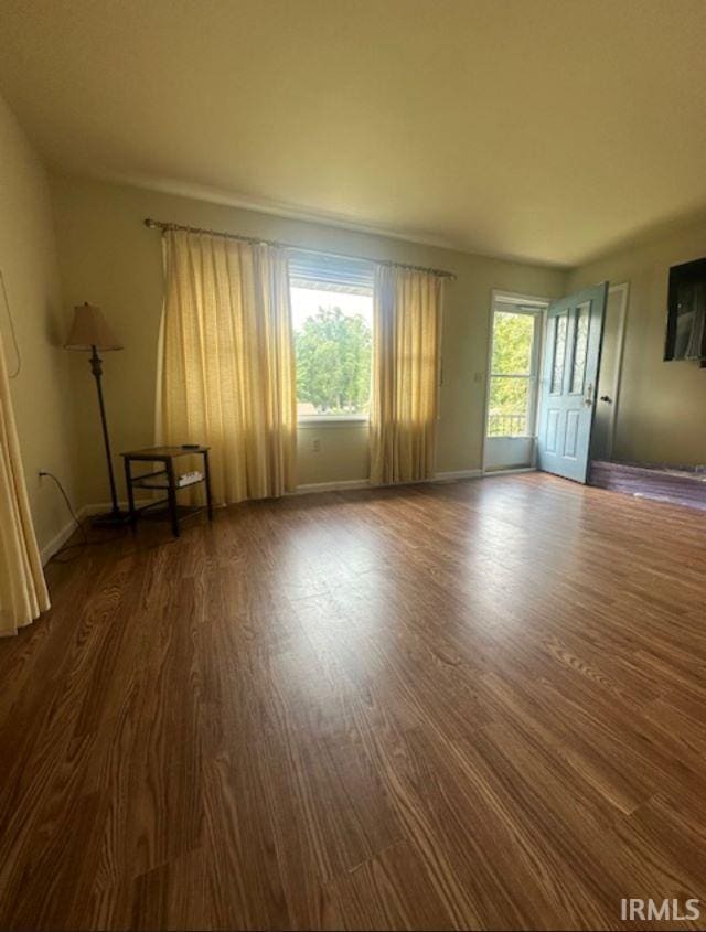 unfurnished room featuring dark hardwood / wood-style flooring