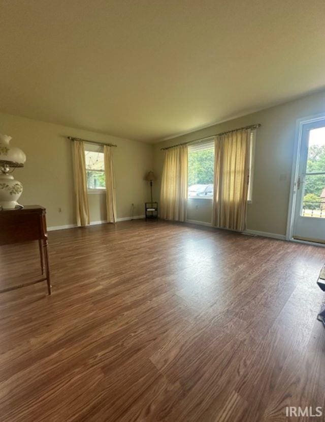 unfurnished room with dark wood-type flooring