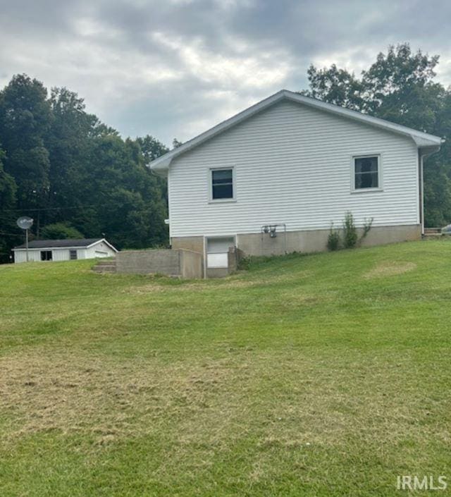 view of side of home featuring a lawn