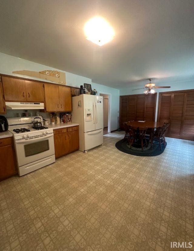 kitchen with white appliances and ceiling fan