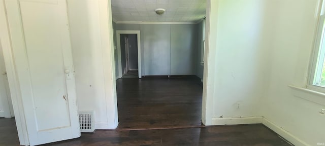 corridor featuring ornamental molding and dark hardwood / wood-style flooring