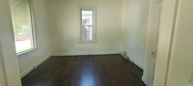 unfurnished room featuring dark hardwood / wood-style floors