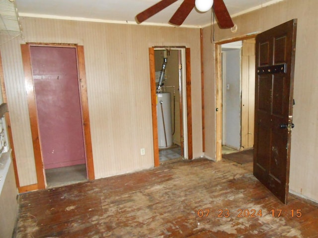 unfurnished bedroom with crown molding, gas water heater, and ceiling fan