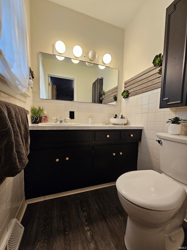 bathroom featuring hardwood / wood-style floors, backsplash, toilet, and vanity