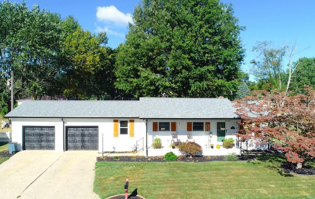 ranch-style house with a garage, covered porch, and a front yard