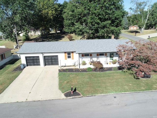 ranch-style home featuring a garage and a front yard