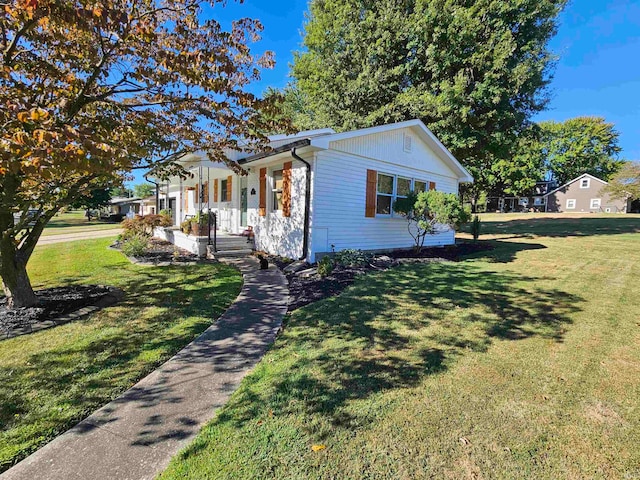 ranch-style house featuring a front lawn and covered porch