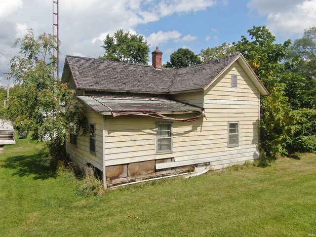 view of property exterior with a lawn