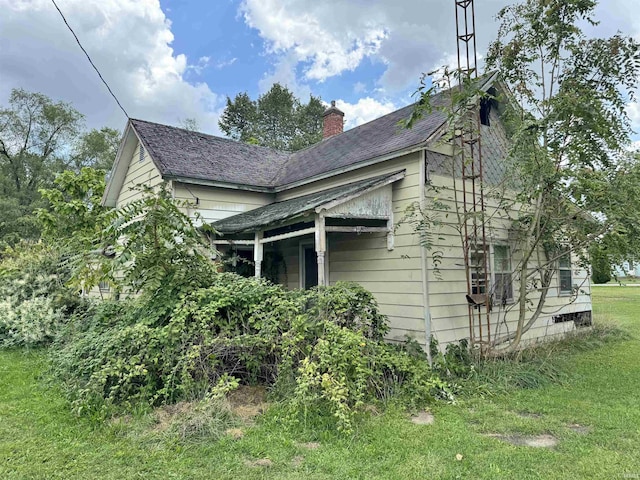 view of property exterior featuring a lawn and a chimney