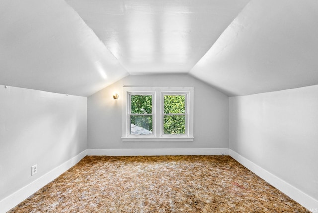 bonus room featuring lofted ceiling and carpet