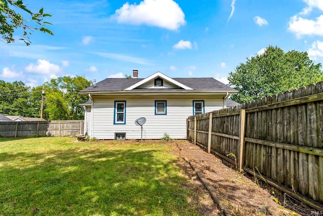 back of house featuring a yard