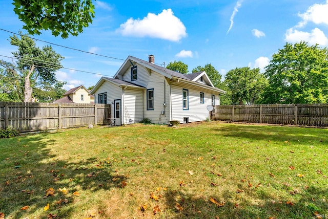 rear view of property with a lawn