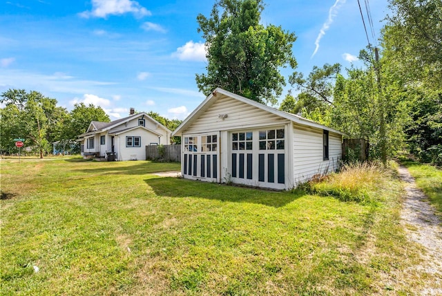 back of house featuring a yard