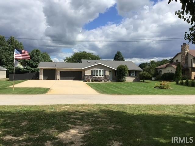 ranch-style home with a garage and a front yard