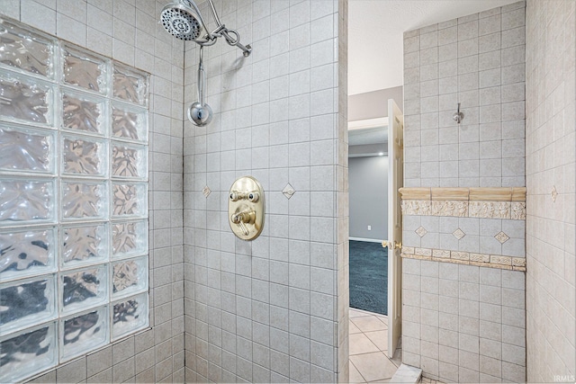 bathroom featuring a tile shower and tile patterned floors