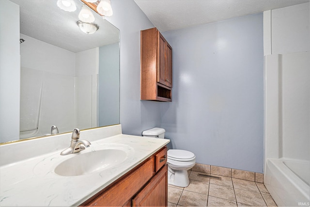 full bathroom featuring tile patterned flooring, a textured ceiling, vanity, and toilet