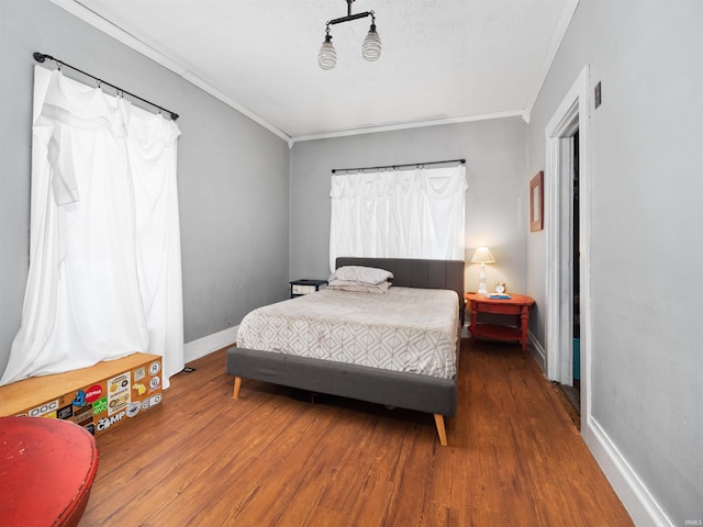 bedroom with crown molding and hardwood / wood-style flooring