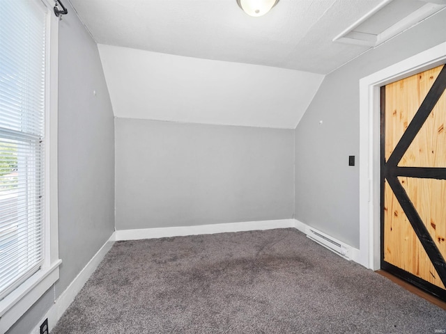 bonus room with a baseboard heating unit, carpet, and vaulted ceiling