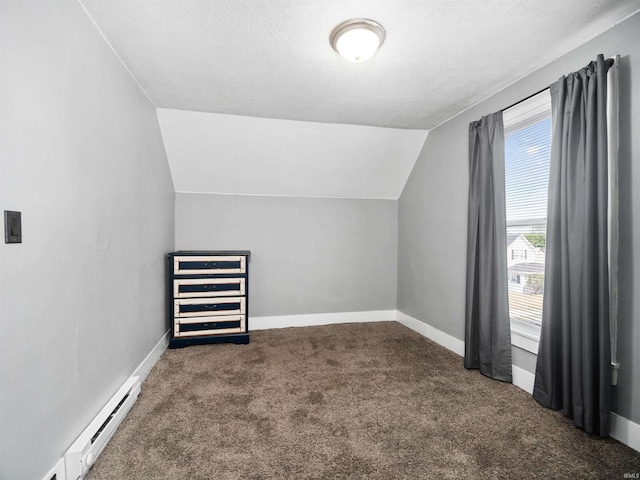 additional living space with vaulted ceiling, a textured ceiling, dark carpet, and a baseboard radiator