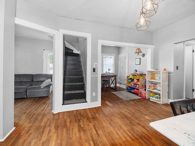 dining space featuring hardwood / wood-style floors and a textured ceiling