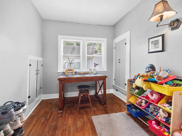 interior space featuring dark hardwood / wood-style floors and a textured ceiling