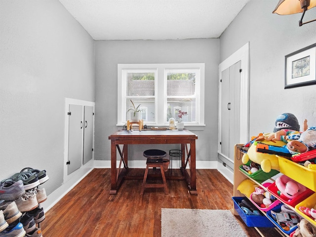 home office with dark wood-type flooring