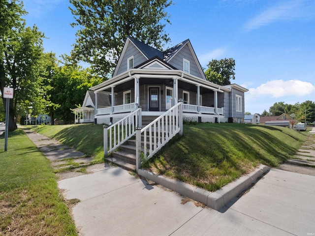 farmhouse inspired home with a front yard and a porch