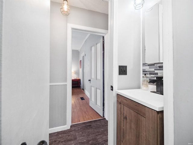 hall featuring a textured ceiling, sink, and dark hardwood / wood-style floors