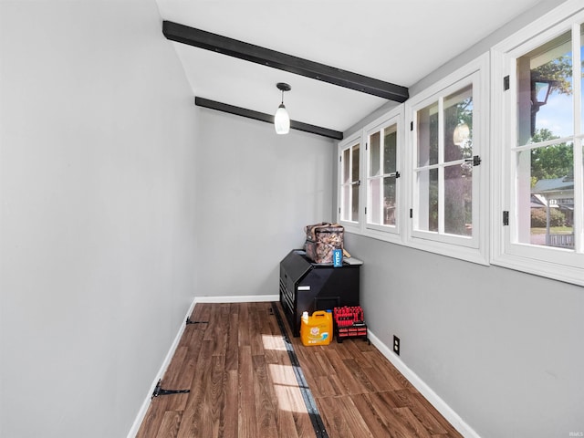 sunroom with lofted ceiling with beams and a healthy amount of sunlight