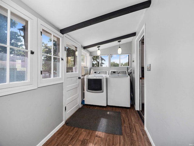 laundry area with dark wood-type flooring, plenty of natural light, and washing machine and dryer