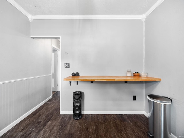 unfurnished office with a textured ceiling, crown molding, and dark hardwood / wood-style floors