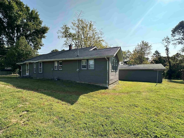 back of house with a lawn