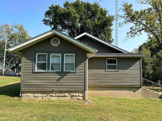 view of side of home with a lawn