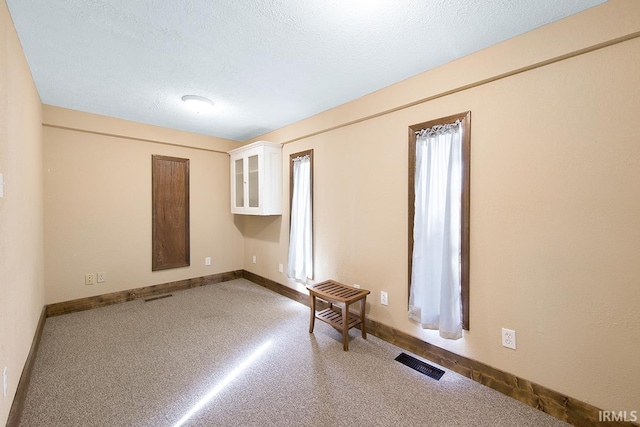 632 W Main St, Peru, IN 46970 - carpeted spare room with visible vents, a textured ceiling, and baseboards