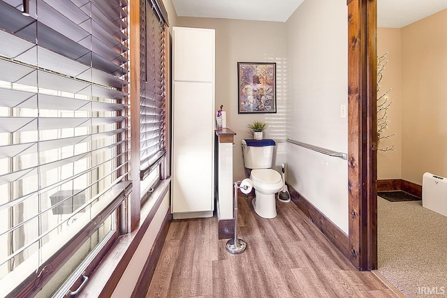 632 W Main St, Peru, IN 46970 - bathroom with baseboards, toilet, and wood finished floors