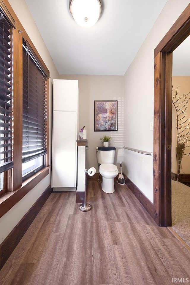 632 W Main St, Peru, IN 46970 - bathroom with baseboards, wood finished floors, and toilet