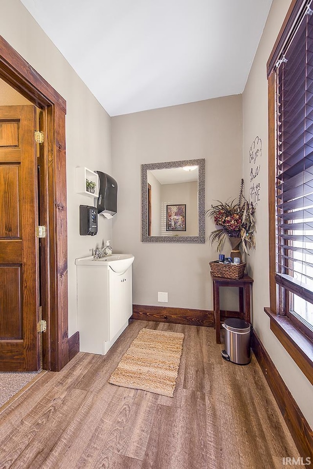 632 W Main St, Peru, IN 46970 - washroom featuring baseboards, a sink, and wood finished floors