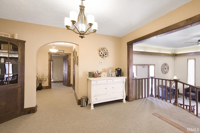 632 W Main St, Peru, IN 46970 - corridor featuring arched walkways, an upstairs landing, carpet flooring, and a notable chandelier