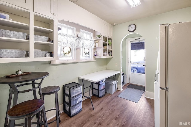 632 W Main St, Peru, IN 46970 - interior space with arched walkways, baseboards, and dark wood finished floors