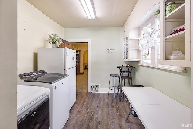 632 W Main St, Peru, IN 46970 - clothes washing area featuring laundry area, visible vents, arched walkways, separate washer and dryer, and dark wood-type flooring