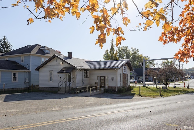 632 W Main St, Peru, IN 46970 - view of front of house with fence, a chimney, and entry steps