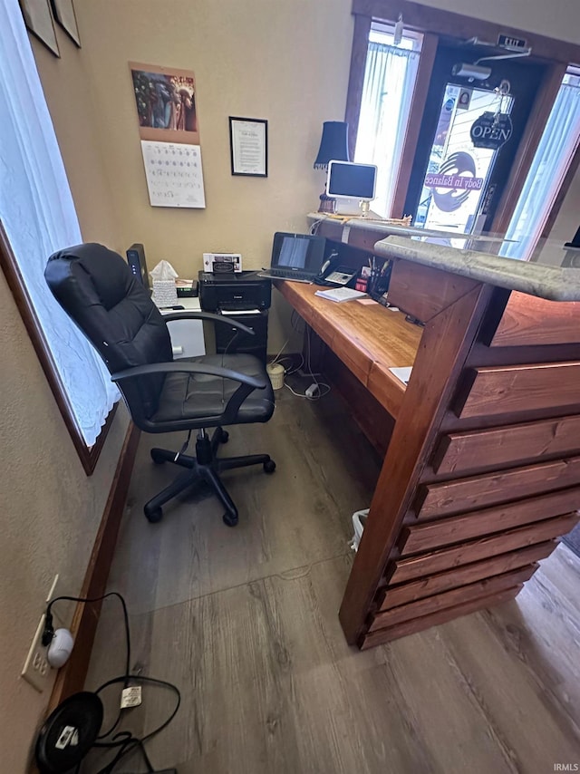 home office with hardwood / wood-style floors