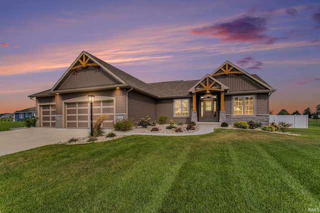 craftsman house with a lawn and a garage