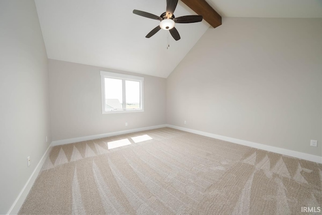 carpeted spare room with ceiling fan and vaulted ceiling with beams